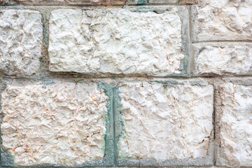 Close-Up of a Textured Stone Wall with Light and Neutral Tones