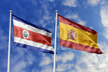 Costa Rica and Spain National Flags Waving Proudly Under a Bright Blue Sky, Symbolizing Strong Historical Ties and Diplomatic Friendship.