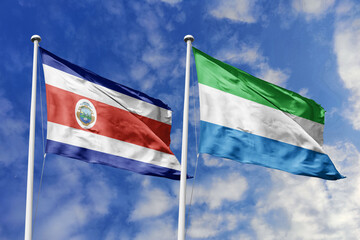 Costa Rica and Sierra Leone National Flags Waving Proudly Under a Bright Blue Sky, Symbolizing Diplomatic Relations and International Friendship.
