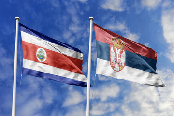 Costa Rica and Serbia National Flags Waving Proudly Under a Bright Blue Sky, Symbolizing Diplomatic Relations and International Friendship.