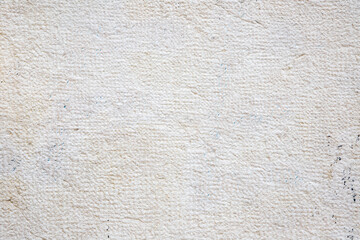 Textured Surface Of A Beige Stone Wall With Natural Cracks