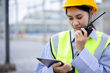Engineer is working at high voltage substation performing inspection and check of power...