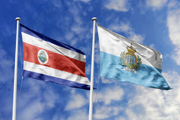 Costa Rica and San Marino National Flags Waving Harmoniously Under a Vivid Blue Sky, Symbolizing Diplomatic Bonds and Global Connections.