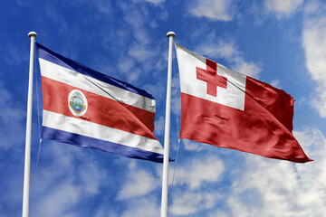 Costa Rica and Tonga National Flags Waving Proudly Against a Dynamic Blue Sky, Representing International Bonds and Global Unity.