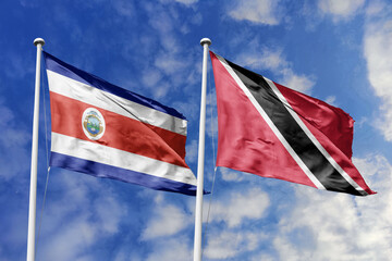 Costa Rica and Trinidad and Tobago National Flags Waving in Unison Against a Vivid Blue Sky, Symbolizing Diplomatic Ties and Friendship.
