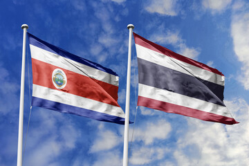 Costa Rica and Thailand flags waving together on a sunny day, symbolizing international relations, friendship, and cooperation between the two nations.
