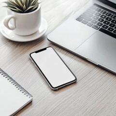 Modern workspace with smartphone and laptop on wooden desk
