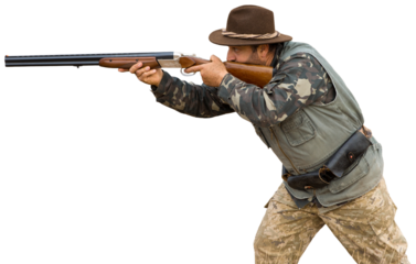 Hunting period, autumn season open. A hunter with a gun in his hands in hunting clothes in the autumn forest in search of a trophy. A man stands with weapons and hunting dogs tracking down the game.