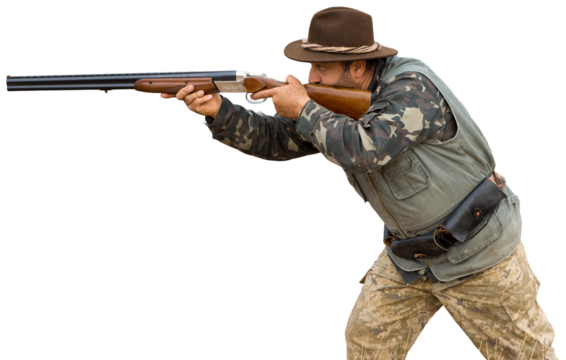 Hunting period, autumn season open. A hunter with a gun in his hands in hunting clothes in the autumn forest in search of a trophy. A man stands with weapons and hunting dogs tracking down the game.