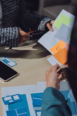 Group of young application developers analyzing uxui mobile app templates during a working meeting