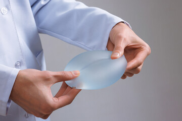 Plastic Surgeon Demonstrates Silicone Breast Implant for Mammoplasty and Cosmetic Surgery Procedure
