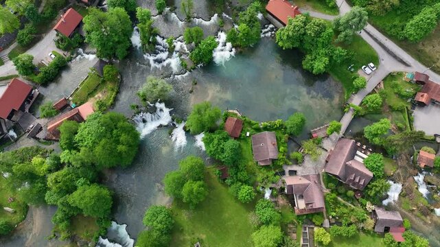 Watermill village Rastoke on rivers Slunj and Korana. Charming village of Rastoke with waterfalls, wooden houses, rivers running through. Aerial view of fairy-tale spring location in heart of Croatia