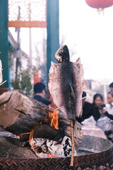 In Qiuci Ancient City, Kuqa City, southern Xinjiang, China, a special - flavored grilled fish is...