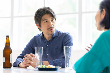 食卓で会話をする夫婦