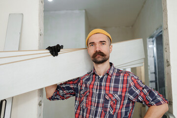 construction worker guy with a drill on a white wall background.master for an hour. construction worker guy with a drill on a white wall background.master for an hour. laying laminate flooring in an a