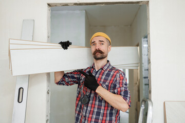 construction worker guy with a drill on a white wall background.master for an hour. construction worker guy with a drill on a white wall background.master for an hour. laying laminate flooring in an a