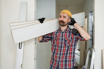 construction worker guy with a drill on a white wall background.master for an hour. construction worker guy with a drill on a white wall background.master for an hour. laying laminate flooring in an a