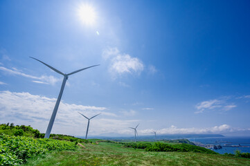 Wind power plants on the hill near the coast in Hokkaido, Japan