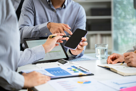 Business documents on office table with smart phone and calculator digital tablet and graph business with social network diagram