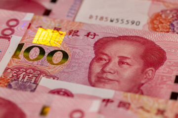 Chinese paper money of one hundred yuan in ultraviolet light, the obverse of genuine Chinese yuan...