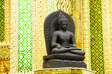 Serene Buddha Statue Surrounded by Golden Temple Architecture