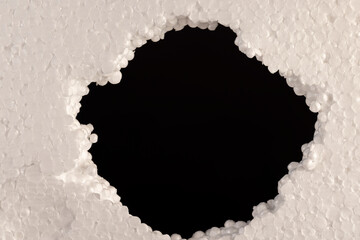 foam for building insulation, foam made from a large number of pieces joined together, a hole in the foam