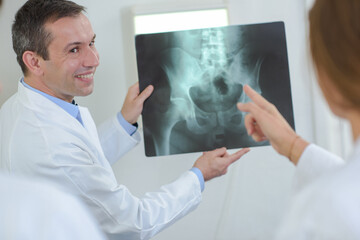 Doctor holding xray, student pointing
