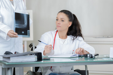 doctor looking at the x-ray picture of hand