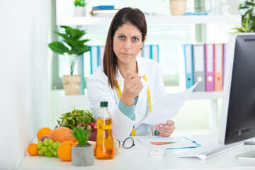 female dietician holding results is cross with patient