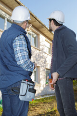 builders looking at unfinished house