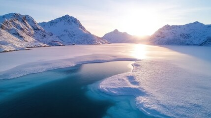 A breathtaking winter landscape showcases icy mountains reflecting sunlight on a serene frozen lake, evoking tranquility and the beauty of nature's untouched charm.