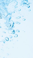 Blue air bubbles underwater closeup light background