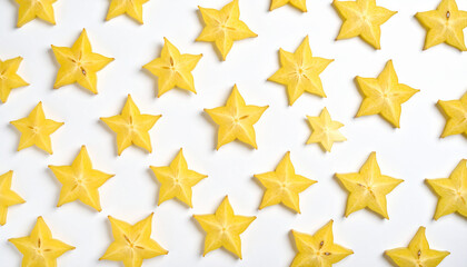 the image displays several star shaped fruit slices arranged on a white background. each fruit section is a vibrant yellow color with a star like shape clearly visible in its cross section
