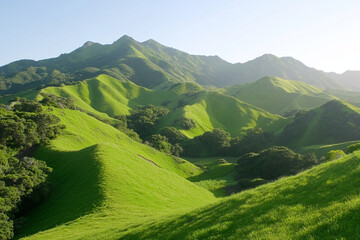 Obraz premium Rural landscape with rolling hills and lush green farmland at sunset