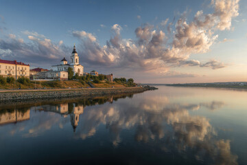 Naklejka premium stunning panorama of ancient building in cheboksary emphasizing flowing river and dramatic clouds above