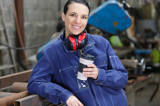 worker in uniform wearing drinking coffee