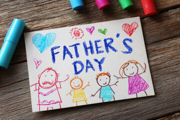 Father?s day card on table with colorful child?s hand-drawn doodles