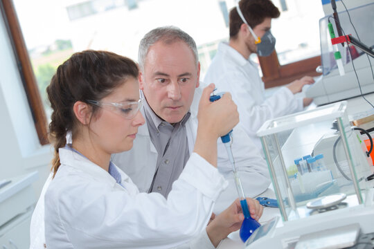 young female student with male professor in lab