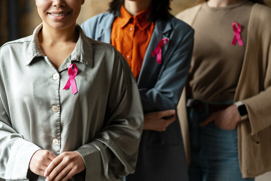 Women wearing pink ribbons showing support for breast cancer awareness