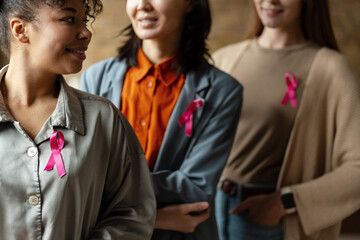 Women wearing pink ribbons showing support for breast cancer awareness