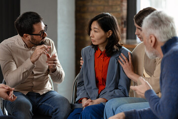 Psychologist supporting patient during group therapy session