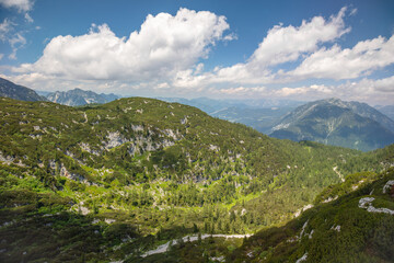 Sunny Day in Forested Mountains and Clouds