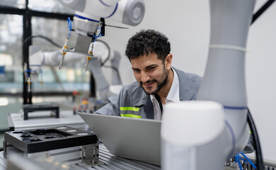Latino robotic development engineer working robot arm connection control at electronic futuristic...