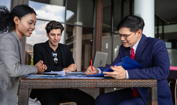 Latino man, African American businessperson, Asian manager brainstorming startup small business strategy. Multiracial businesswoman and colleague serious working on planning. Diversity people team.