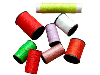 Several colorful spools of thread in red, green, white, pink, and yellow arranged together.