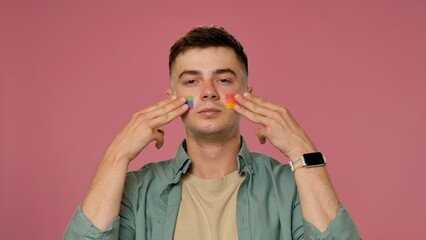 Man with Rainbow Stripes on Cheeks and Pink Background