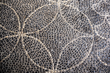 Traditional pattern cobblestone pavement (calçada portuguesa) in Funchal, Madeira, Portugal 