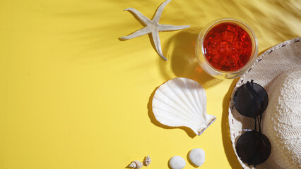Arranged flat lay of cold refreshing beverage strawberry or cranberry drink, straw hat, sunglasses,...