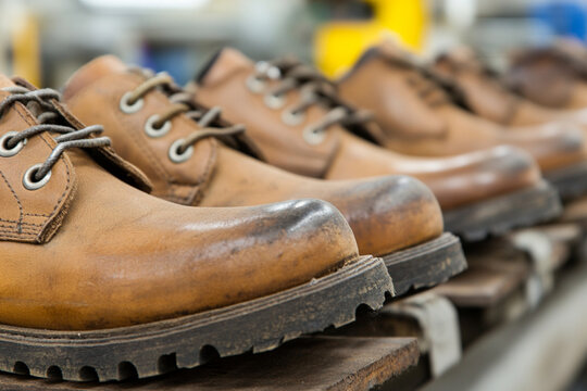 Shoemaking process of attaching soles to footwear in a workshop
