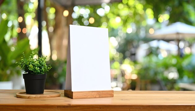 Blank sign with plant in a vibrant outdoor setting.